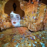 TOPSHOT - A person attends the opening press preview of Hall des Lumières, New York Citys new permanent center for immersive digital art experiences, on September 13, 2022. - The immersive exhibit at the former Emigrant Savings Bank features the iconic works of Gustav Klimt and several other artists. - RESTRICTED TO EDITORIAL USE - MANDATORY MENTION OF THE ARTIST UPON PUBLICATION - TO ILLUSTRATE THE EVENT AS SPECIFIED IN THE CAPTION (Photo by TIMOTHY A. CLARY / AFP) / RESTRICTED TO EDITORIAL USE - MANDATORY MENTION OF THE ARTIST UPON PUBLICATION - TO ILLUSTRATE THE EVENT AS SPECIFIED IN THE CAPTION / RESTRICTED TO EDITORIAL USE - MANDATORY MENTION OF THE ARTIST UPON PUBLICATION - TO ILLUSTRATE THE EVENT AS SPECIFIED IN THE CAPTION (Photo by TIMOTHY A. CLARY/AFP via Getty Images)